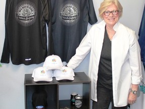 Screenprintz graphic designer Diane Robb stands with a selection of Canada 150 and vintage safety awareness gear at the store's Davis Street location in Sarnia. The company is the only licensed distributor of Canada 150 gear in Lambton County. 
CARL HNATYSHYN/SARNIA THIS WEEK