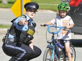 Ethan Dickson, 5, of Mitchell, received some pointers from OPP Auxiliary Officer Connor Dewbury during the annual Optimist Club of Mitchell Bike Rodeo last Saturday, June 3 at the West Perth fire hall in Mitchell. ANDY BADER/MITCHELL ADVOCATE