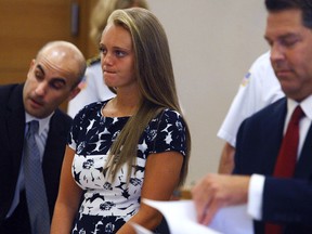 In this July 29, 2016, file photo Michelle Carter stands with her attorneys at the Bristol County Juvenile Court in Taunton, Mass. Jury selection is set to begin Monday, June 5, 2017, in the trial of Carter who is accused of sending her boyfriend dozens of text messages encouraging him to kill himself. (George Rizer/The Globe via AP, Pool, File)