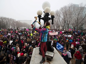 People take part in a rally at the Alberta Legislature.  The Edmonton event is one of about 10 across Canada on Wednesday January 21, 2017. The event is in support of a Washington march for women's rights to protest the inauguration of U.S. president Donald Trump. Greg Southam/Postmedia