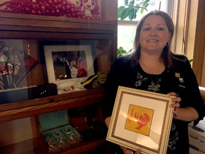 Mayor Heather Jackson shows some memorabilia she’s collected during her trips to St. Thomas’s sister city in China, Xuyi. She and St. Thomas Economic Development general manager Sean Dyke will be traveling once again Friday in an attempt to further the two cities relationship. (Jennifer Bieman/Times-Journal)