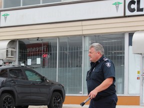 Fire prevention inspector James Marshall spent several hours at 1472 Dundas St., a commercial building that houses Healing Health Compassion, on Monday. (DALE CARRUTHERS, The London Free Press)