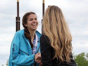 Anna Workman of Kingston Collegiate, left, is congratulated after receiving her gold medal for winning the midget girls 400-metre final on Friday at the Ontario Federation of School Athletic Associations track and field championships in Belleville. Workman also won gold in the 800 metres on Saturday. (David Foot/Supplied photo)