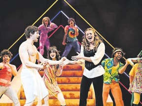 Jamie McKnight as Joseph and Danielle Wade as Narrator perform a scene with the ensemble in Joseph and the Amazing Technicolor Dreamcoat, opening Thursday at Huron Country Playhouse. (Hilary Gauld-Camilleri/Special to Postmedia News)