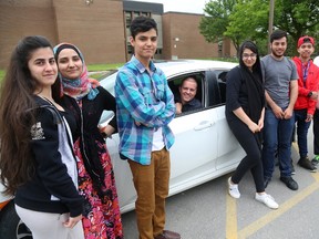 Mike MacLaren teaches Discovering the Workplace at Montcalm and as part of the ESL teaching he's helping students get their driver's licences in London, Ont. From left are Laila Youssef, Lima Khoaja, Mansoor Khoaja, Zhila Amiry, Sherbel Mosha, John Paul Ramos, and Zirui Wang. Photograph taken on Monday June 5, 2017. (MIKE HENSEN, The London Free Press)