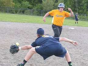 Devon Yaroshuk of Bishop Alexander Carter Catholic Secondary School tries to make the catch as Caleb Legros of College Notre Dame tries to make it to third base during boys high school slo-pitch championship game action in Sudbury, Ont. on Monday June 5, 2017. Legros made to third base safely but Bishop Carter defeated Notre Dame to capture the city championship.Gino Donato/Sudbury Star/Postmedia Network