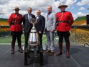 RCMP Cst. Jessica Brown, Jim Lawson, Chair of the Board of Governors of the Canadian Football League, Brad Sparrow, Chair, Board of Directors, Edmonton Eskimos, Edmonton Eskimos President and CEO, Len Rhodes and RCMP Cpl. David Brosinski pose with the Grey Cup after the Canadian Football League (CFL) announced that Edmonton will host the 2018 Grey Cup. Taken on Monday June 5, 2017, in Edmonton.