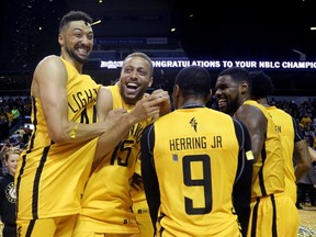London Lightning players Ryan Anderson, left, and Garrett Williamson show their delight after beating the Halifax Hurricanes for the NBL of Canada title at Budweiser Gardens on Monday night. (MIKE HENSEN, The London Free Press)