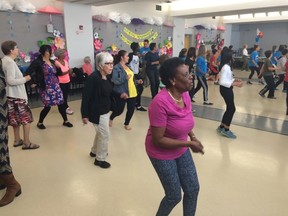 Grade 6 students from St. Philip Catholic Elementary School tried to keep up with the Sage Seniors' Zumba class to kick off Seniors' Week activities. Dustin Cook / Postmedia