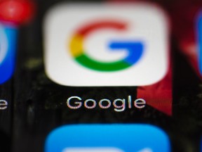 This April 26, 2017, file photo shows a Google icon on a mobile phone in Philadelphia. Google is spearheading an educational campaign to teach pre-teen children how to protect themselves from scams, predators and other trouble. The program announced Tuesday, June 6, is called “Be Internet Aware.” (AP Photo/Matt Rourke, File)
