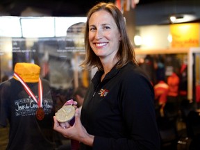 Former Olympic and Canada Summer Games rower Janine Stephens holds up her 2012 Summer Olympics silver medal with one of her 2001 Canada Summer Games bronze medals and her jersey in the display case behind at an exhibit at the Manitoba Sports Hall of Fame in Winnipeg to commemorate the 50th anniversary of the Canada Games on Tuesday, June 6, 2017. The new exhibit was unveiled Tuesday and will run until the spring of 2018. The Canada Summer Games run from July 28 to Aug. 13 and will feature 16 sports and over 250 events. SCOTT BILLECK/Winnipeg Sun/Postmedia Network