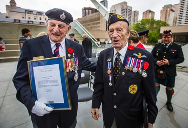Second World War veteran Trooper Edward Stafford (left) chats with fellow Second World War veteran Capt. Martin Maxwell at the end the commemoration of the 73rd anniversary of D-Day and the Battle of Normandy during the Second World War at a ceremony held at Nathan Phillips Square in Toronto, Ont. on Tuesday June 6, 2017. Ernest Doroszuk/Toronto Sun/Postmedia Network