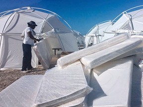 This file photo provided by Jake Strang shows mattress and tents set up for attendees of the Fyre Festival, Friday, April 28, 2017, in the Exuma islands, Bahamas.  (Jake Strang via AP, File)