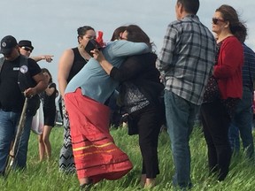 Melinda Wood (right) is hugged by Morene Gabriel at a vigil for Christine Wood, near the spot where the 21-year-old murder victim's body was found near an isolated stretch of road west of Dugald, located east of Winnipeg.
David Larkins/Winnipeg Sun/Postmedia Network