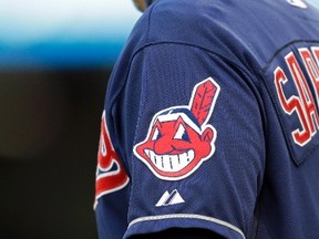 In this April 8, 2014 photo, the Cleveland Indians Chief Wahoo logo is shown on the uniform sleeve of third base coach Mike Sarbaugh during a baseball game against the San Diego Padres in Cleveland, Ohio. (THE CANADIAN PRESS/AP-Mark Duncan)