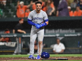 Toronto Blue Jays' Devon Travis reacts after striking out in the rain against the Baltimore Orioles during the 10th inning of an MLB game on May 19, 2017. (AP Photo/Gail Burton)
