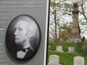 Alexander Mackenzie is remembered on a commemorative plaque that stands in the shadow of his deteriorating sandstone grave monument in Sarnia. (Tyler Kula/Sarnia Observer/Postmedia News)