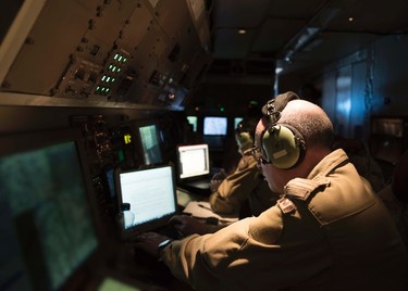 Air Combat System Officers onboard a CP-140 Aurora patrol aircraft log in their observations during a  reconnaissance mission as part of Operation IMPACT on January 1, 2017. 

Photo: Op Impact, DND