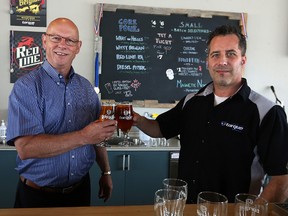 Sandy Hopkins (left), the CEO of Habitat for Humanity Manitoba, and John Heim, president of Torque Brewing, cheers the launch of Foundation APA in Torque's taproom on King Edward Street in Winnipeg on Wed., June 7, 2017. A $4 donation will be made to Habitat from each 12 pack of cans sold, and $1 from each pint poured in the taproom. Kevin King/Winnipeg Sun/Postmedia Network
Kevin King/Winnipeg Sun