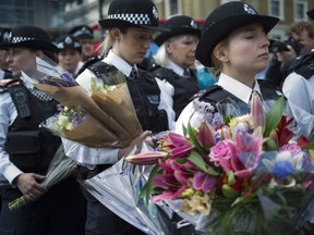 Police officers arrive to lay flowers near the scene of the London Bridge terrorist attacks, on June 7, 2017, in London, England. The third attacker has been named following the attack on Saturday night in London Bridge and Borough in which eight people were killed and forty eight were injured. (GETTY IMAGES/PHOTO)