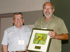 Larry Cornelis, right, receives the Ontario Nature Achievement Award from Otto Peter, of Ontario Nature. (Handout)