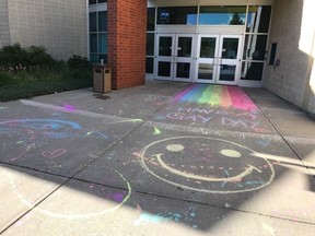 Chalk pride week drawings student created outside Blessed Oscar Romero High School Tuesday. Students were asked to wash them off.