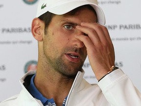 Serbia's Novak Djokovic answers reporters after losing to Austria's Dominic Thiem in a quarterfinal match of the French Open tennis tournament at the Roland Garros stadium, Wednesday, June 7, 2017 in Paris. (AP Photo/David Vincent)