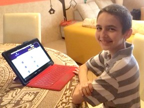 Kelton Kostis, 12, is pictured here a year ago when he was working on earning bachelor of science degree in web technology from Nebraska's Bellevue University. He has since graduated and is working on his masters degree information systems with a focus on cybersecurity. (Handout)