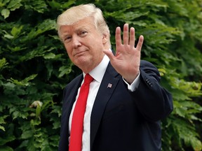 U.S. President Donald Trump waves as he walks back into the White House in Washington following his arrival on Marine One, Wednesday, June 7, 2017. Trump was returning from Cincinnati. (AP Photo/Pablo Martinez Monsivais)