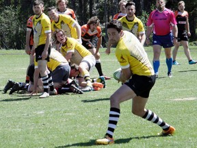 Banff Bears' Jonah Hann looks to pass the ball during a Calgary Rugby Union Div. 3 clash between the Banff Bears and Foothills Lions at the Banff Recreation Grounds in Banff, Alta. on Saturday, June 3, 2017. The Bears defeated the Lions 27-7. (Russ Ullyot/ Bow Valley Crag & Canyon/ Postmedia Network)