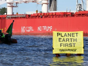 Activists of Greenpeace have painted ‘No Coal No Trump’ of the side of the ‘SBI Subaru’ ship with some 60,000 tons of coal from Texas on board in Hamburg, nothern Germany on June 1, 2017. (Getty Images)