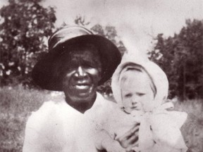 This 1916 photo provided by the Archdiocese of Denver shows Julia Greeley with Marjorie Ann Urquhart in McDonough Park in Denver.  (Archdiocese of Denver via AP)