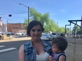 Julia Carriere with her one-year-old son Richard outside an Edmonton courthouse on June 7, 2017, after graduating from the Edmonton Drug Treatment Court Service. Clare Clancy / Postmedia