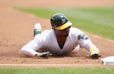 Rajai Davis #11 of the Oakland Athletics steals third base in the first inning against the Toronto Blue Jays at Oakland Alameda Coliseum on June 7, 2017 in Oakland, California.  (Photo by Ezra Shaw/Getty Images)