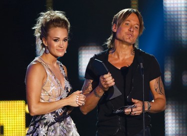 Carrie Underwood, left, and Keith Urban accept the award for collaborative video of the year for "The Fighter" at the CMT Music Awards at Music City Center on Wednesday, June 7, 2017, in Nashville, Tenn. (Photo by Wade Payne/Invision/AP)