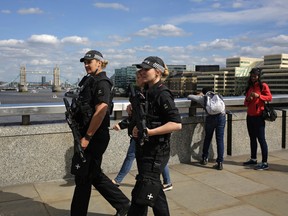 Armed police officers patrol on London Bridge in London, Wednesday, June 7, 2017. (AP Photo/Markus Schreiber)
