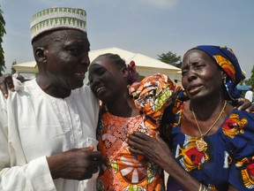 Family members celebrate after being reunited with the  kidnapped schoolgirls in Abuja, Nigeria, Saturday, May 20, 2016. Officials say the 82 Nigerian schoolgirls recently released after more than three years in Boko Haram captivity are reuniting with their families for the first time. AP Photo/Olamikan Gbemiga