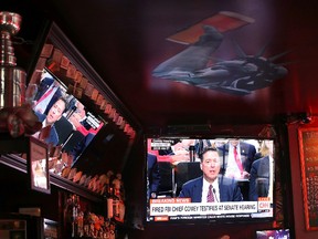 A television broadcast of former FBI Director James Comey testify before the Senate Intelligence Committee plays at Ace's Bar on June 8, 2017 in San Francisco, United States. (Photo by Justin Sullivan/Getty Images)