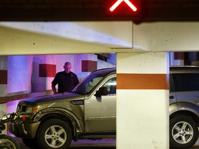 Edmonton Police Service officers watch a Dodge Nitro after a shooting victim was apparently dropped off at the Emergency Room at Royal Alexandra Hospital in Edmonton on June 7, 2017.