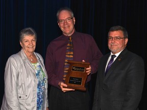 Rainbow District School Board chair Doreen Dewar, left, and director of education Norm Blaseg, right, present a Community Partnership Award to Sudbury Star sports columnist Randy Pascal during an awards ceremony on Tuesday. Photo supplied