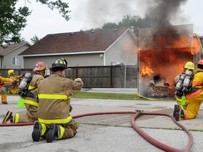 Firefighters in Corunna prepare to extinguish a demonstration blaze at last year's Field Days. The annual event that includes concerts, a parade and fire safety demonstrations kicks off Friday. (Handout)