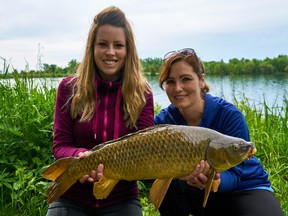 Columnist Ashley Rae, left, and friend Jenn Mulvihill with a carp caught on the St. Lawrence River. (Submitted photo)