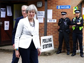Britain's Prime Minister Theresa May leaves with her husband Philip after voting in the general election at a polling station in Maidenhead, England, on Thursday, June 8, 2017. (AP Photo/Alastair Grant)