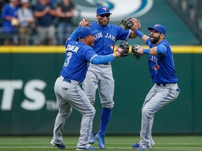 Members of the Toronto Blue Jays celebrate after defeating the Seattle Mariners at Safeco Field on July 25, 2015. (Otto Greule Jr/Getty Images)