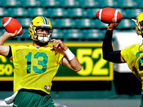 Edmonton Eskimos quarterbacks Mike Reilly (left) and James Franklin (right) throw the ball in tandem during team practice at Commonwealth Stadium in Edmonton on Thursday June 8, 2017.