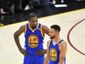 Kevin Durant and Stephen Curry of the Golden State Warriorschat during Game 3 gainst the Cleveland Cavaliers at Quicken Loans Arena on June 7, 2017. (Jason Miller/Getty Images)