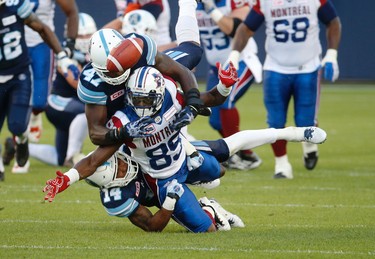 Toronto Argonauts Qudarius Ford DB (14)  and  Nakas Onyeka LB (41) chase down Montreal Alouettes TJ Graham WR (89) and causes the no catch the second quarter during pre-season CFL action in Toronto, Ont. on Thursday June 8, 2017. Jack Boland/Toronto Sun/Postmedia Network