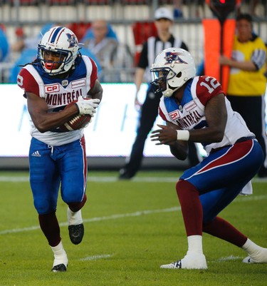 Montreal Alouettes Jacory Harris QB (12) hands off to Deandre Reaves WR (2) during second quarter pre-season CFL action in Toronto, Ont. on Thursday June 8, 2017. Jack Boland/Toronto Sun/Postmedia Network