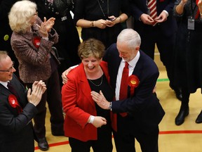 Britain's Labour party leader Jeremy Corbyn, right, tries to high-five with Labour's Emily Thornberry after arriving for the declaration at his constituency in London, Friday, June 9, 2017. Britain voted Thursday in an election that started out as an attempt by Prime Minister Theresa May to increase her party's majority in Parliament ahead of Brexit negotiations but was upended by terror attacks in Manchester and London during the campaign's closing days. (AP Photo/Frank Augstein)