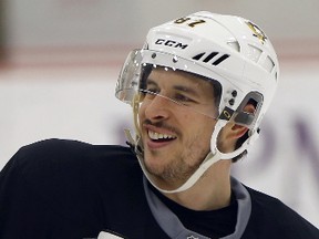 Pittsburgh Penguins' Sidney Crosby smiles during NHL hockey practice, Friday, May 5, 2017, at the team's practice facility in Cranberry, Pa. It was Crosby's first time back on the ice since he suffered a concussion in Game 3 of Pittsburgh's playoff series against Washington. (AP Photo/Keith Srakocic)